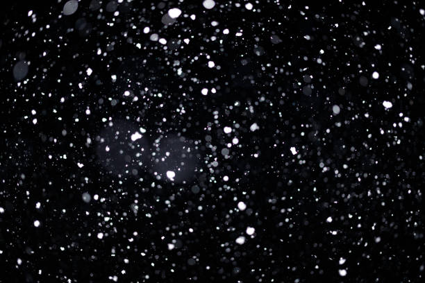 istock Real falling snow on black background for blending modes in ps. Ver 06 - many snowflakes in blur 1309244193