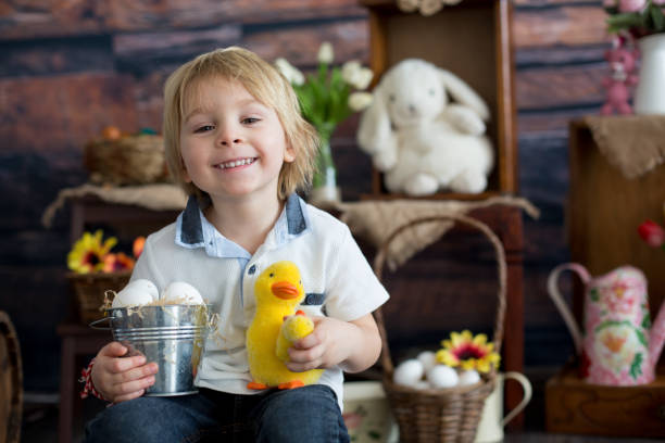 istock Cute toddler blond child, boy with easter decoration 1309244352