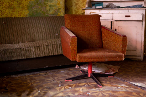 istock Armchair, sideboard and bed in an old abandoned house 1309246477