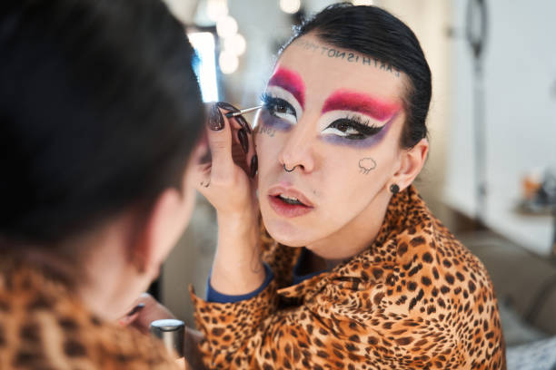 istock Drag queen with long nails looking at his reflection at the mirror 1309247043