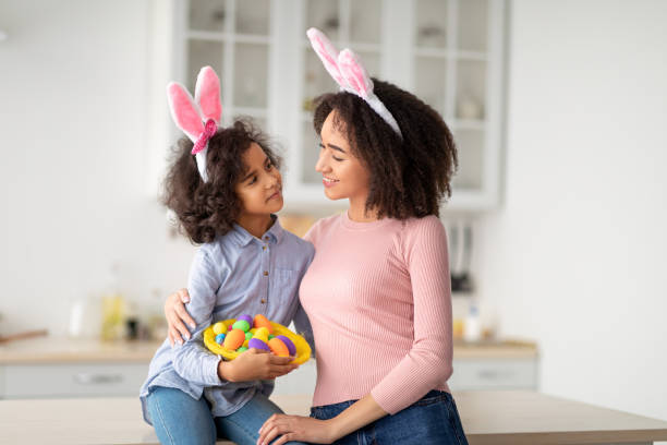 istock Black girl and lady wearing bunny ears on Easter day 1309247190