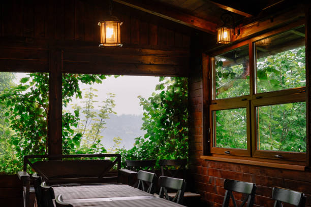 istock Interior Of Wood Cabin With Empty Chairs And Tables Against Window 1309248933