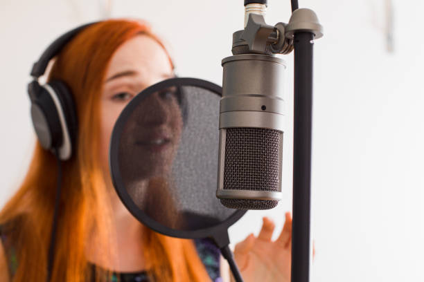 istock Close-Up Of Singer Singing Song At Studio 1309250825