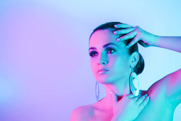 istock Young Woman Looking Away Against Colored Background 1309251818