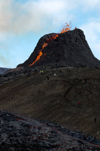 People are watching the volcano eruption at Fagradalsfjall, Iceland. stock photo