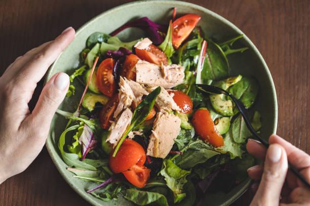 istock Woman eating salad with tuna. 1309253532