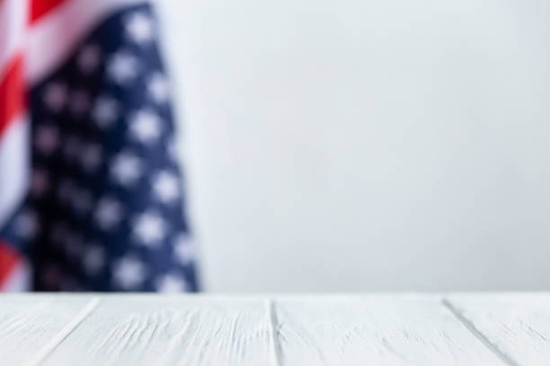 istock Us flag background. American flag with white wood table and copy space 1309255004