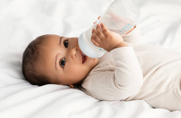 istock Cute little African American baby drinking from bottle 1309255100