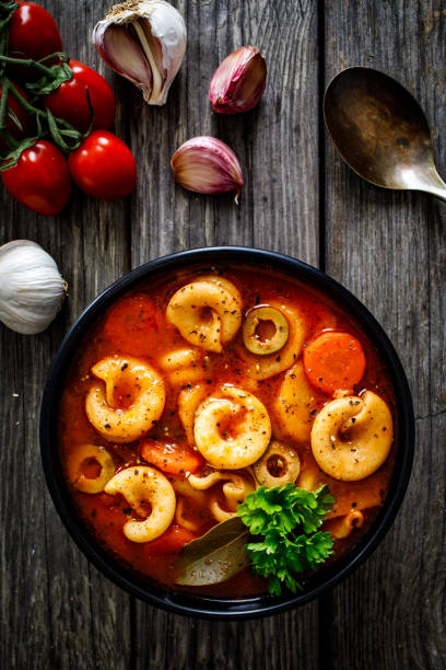 istock Tomato soup with noodles on wooden background 1309255356