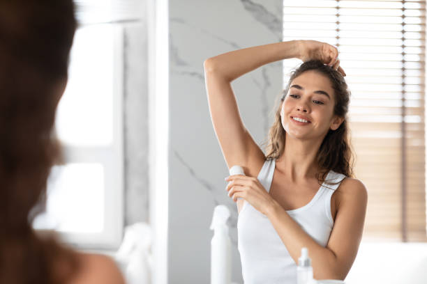 istock Lady Applying Antiperspirant Roll Underarms For Armpits Freshness In Bathroom 1309255451