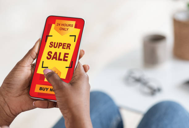 istock Black woman using shopping application on smartphone, super sale concept 1309255482