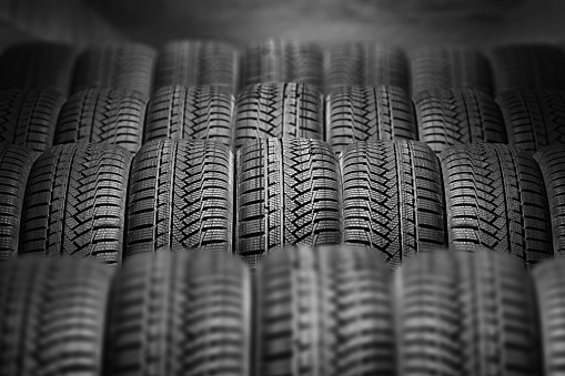 a lot of new car tires in the warehouse. store season tires.