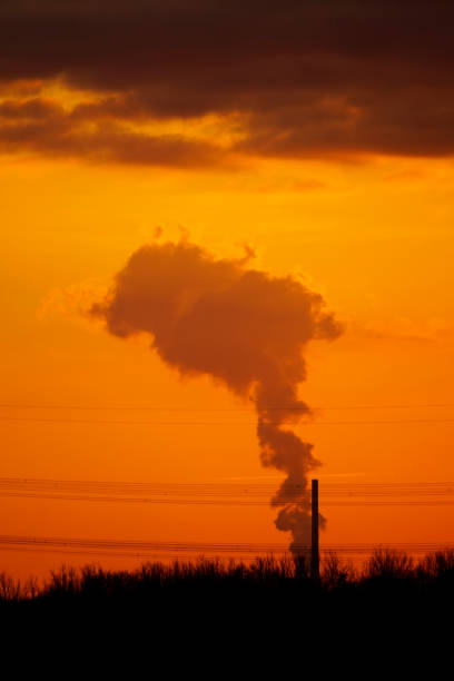 istock Dark smoke with orange sky at sunset 1309258244