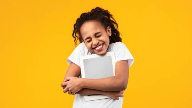 istock Technology Lover. Excite black girl hugging personal computer 1309259534