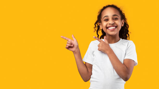istock Excited black girl pointing aside at free copy space 1309259732