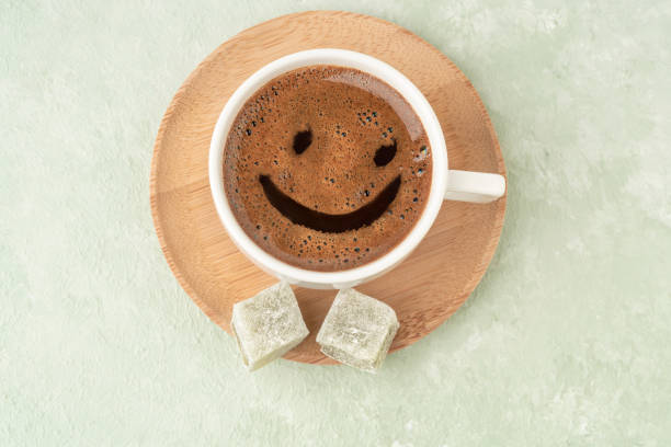 istock Smiley face shape on a cup of coffee and Turkish delights 1309262293
