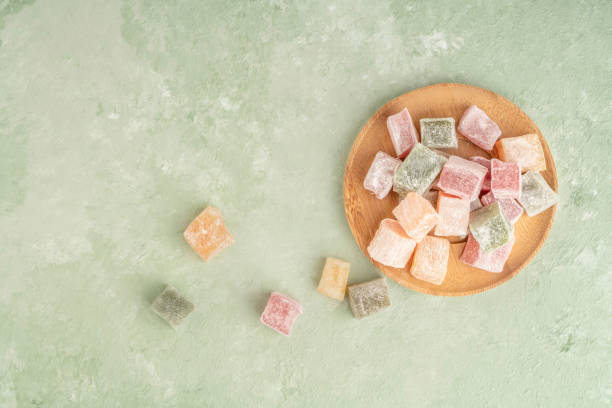 colorful turkish delights on the plate on green - turkish delight imagens e fotografias de stock