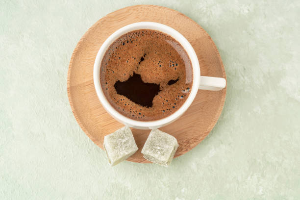 istock cup of coffee and Turkish delights on a green table 1309262304