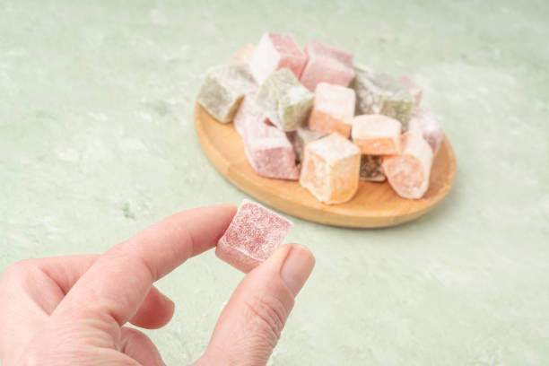 istock hand picks Turkish delight from the plate 1309262388