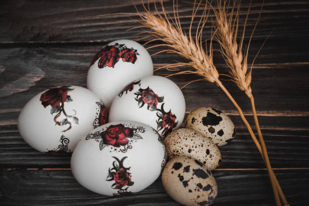 Easter painted and quail eggs on a wooden table. Side view.