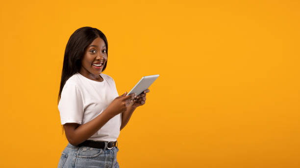 istock Cheerful african american lady using mobile application on pad 1309263107
