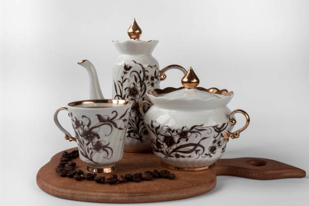 istock Coffee pot and two cups on a wood surface, a white background. 1309264168
