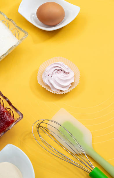 istock Ingredients with tools for making marshmallows. Sugar, jam, flour, whisk, spatula, marshmallow and egg on a yellow background. Selective focus. 1309264465