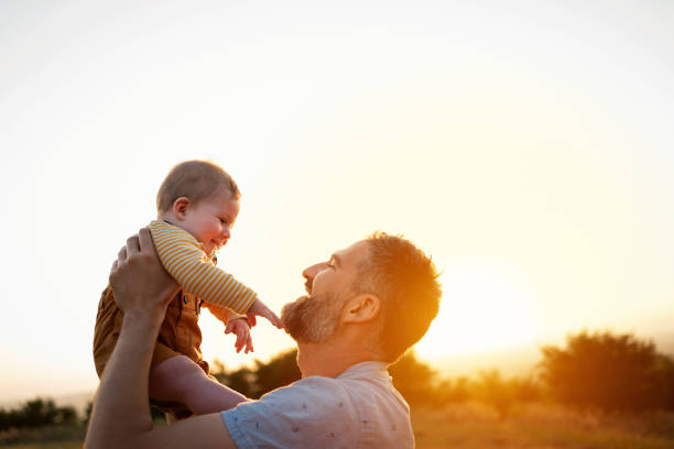 istock Father lifting his son in the air 1309266084