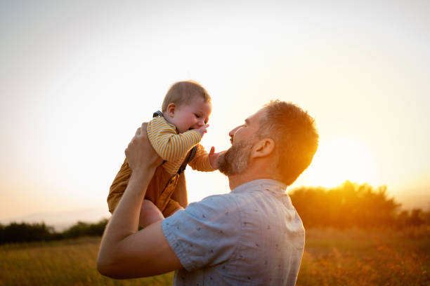 istock Baby boy and his father laughing together 1309266100