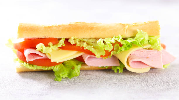 istock sandwich- baguette with ham, cheese, lettuce and tomato 1309266294