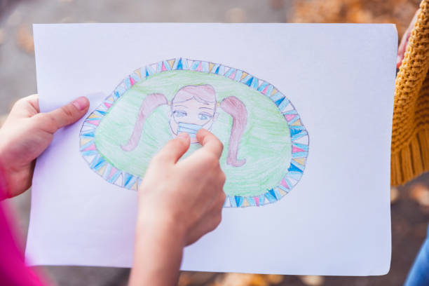 istock Child holding a drawing, close up 1309266358