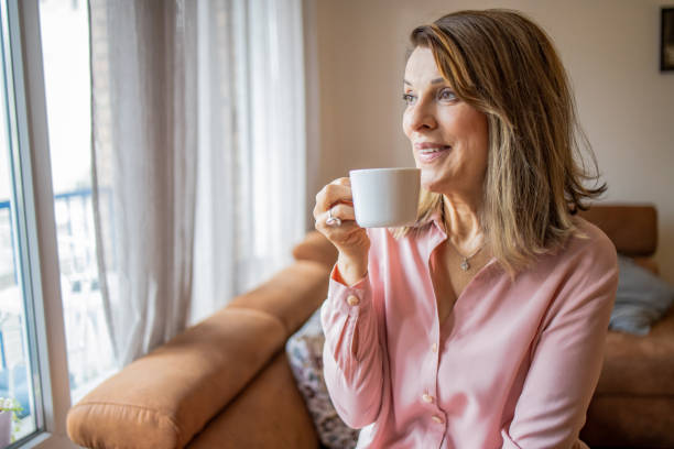 istock Mature woman enjoying at home and drinking coffee 1309269331