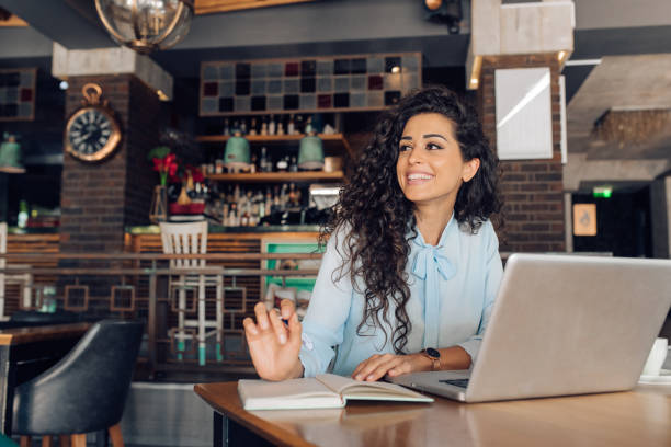 istock Beautiful female entrepreneur working from the cafe 1309274084