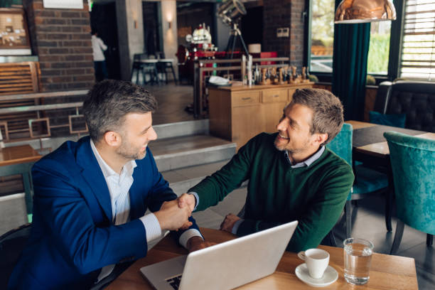 istock Business partners shaking hands at the cafe after a successful cooperation 1309274109