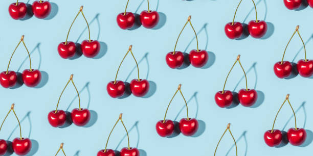 istock A ripe cherry berries on a blue background. 1309274795