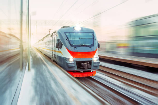 istock Speed suburban train with motion blur rides city station. 1309276790