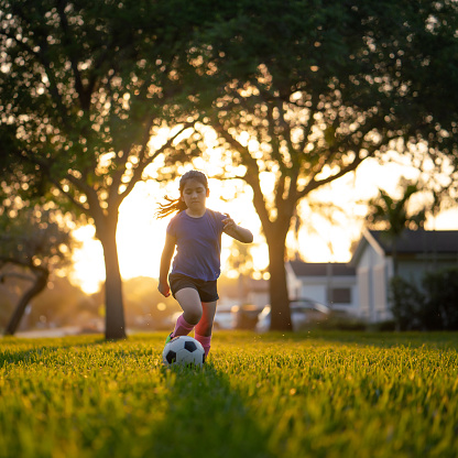Soccer practice in the park at sunset
