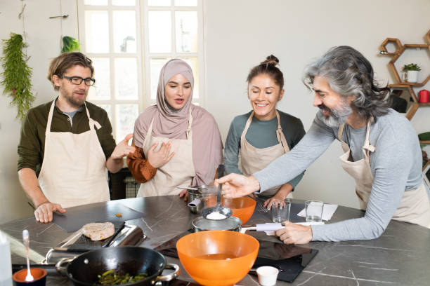 istock Happy mature bearded man holding kitchen tool over metallic pan with boiling water while cooking 1309278238