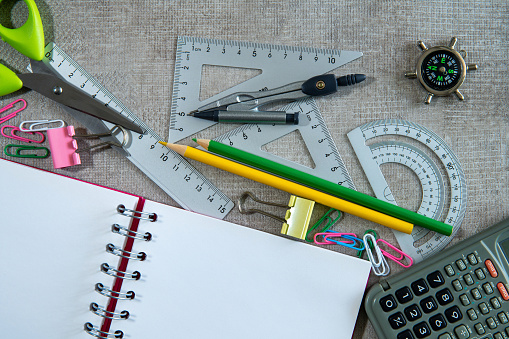 Spiral notebook and stationery on gray background