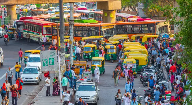 Life and big traffic with Tuk Tuks buses and people in New-Delhi Delhi India.