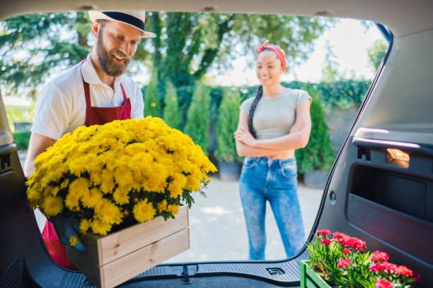 istock Florist placing flowers in client's car 1309281643