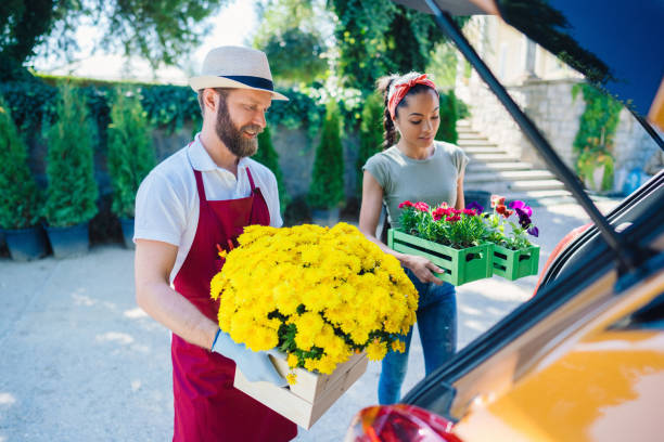 istock Florist placing flowers in client's car 1309281669