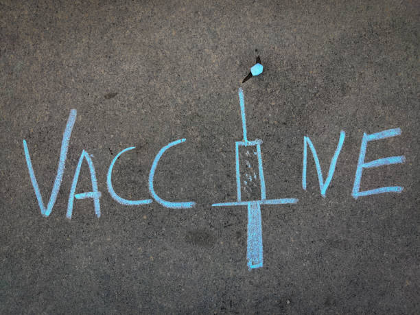 istock The inscription text on the grey board, Vaccine with hand drawn injection . Using color chalk pieces. 1309282354