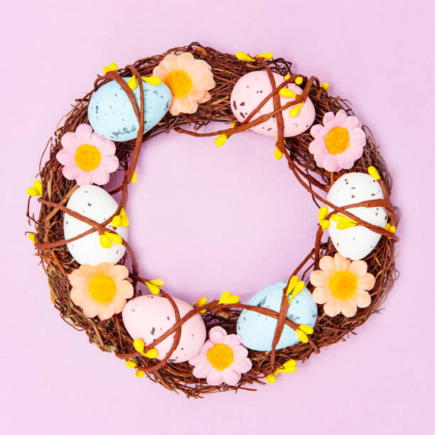 istock Home interior decoration wreath with colorful easter eggs on pink background 1309284564