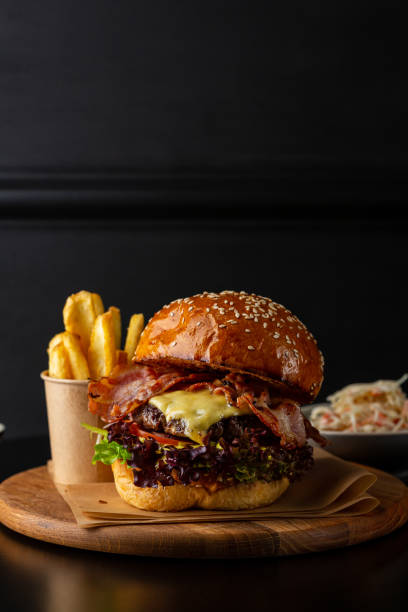 istock Close up of meat hamburger with cheese and bacon 1309286043