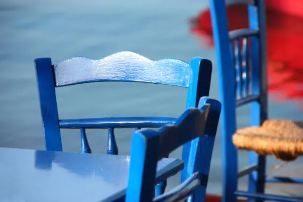 Typical blue chairs and table by the sea, Serifos, Greece.