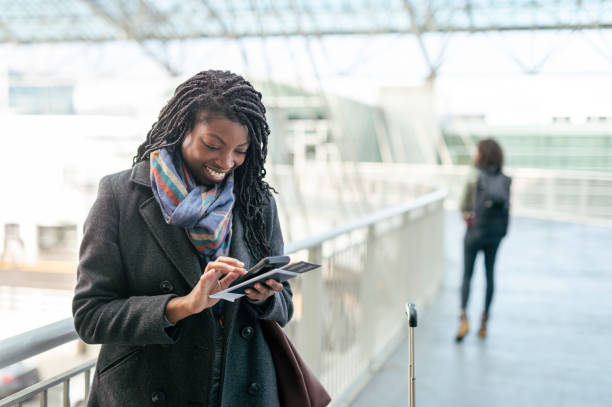 istock Ethnic Woman Texting While Traveling Through Airport 1309289404