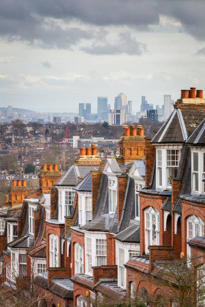 View across city of London from Muswell Hill The red brick Victorian row houses of Muswell Hill with panoramic views across to the skyscrapers and financial district of the city of London. window chimney london england residential district stock pictures, royalty-free photos & images