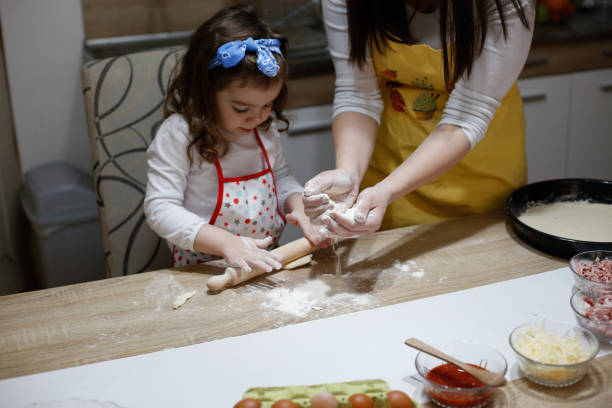 istock Family making pizza.stock photo 1309290572