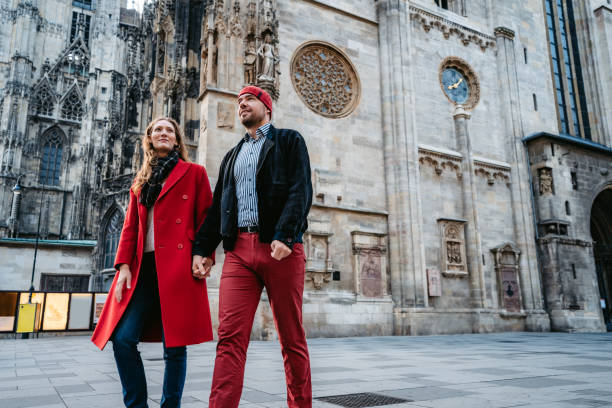 istock Happy couple walking over town square in Vienna 1309292412